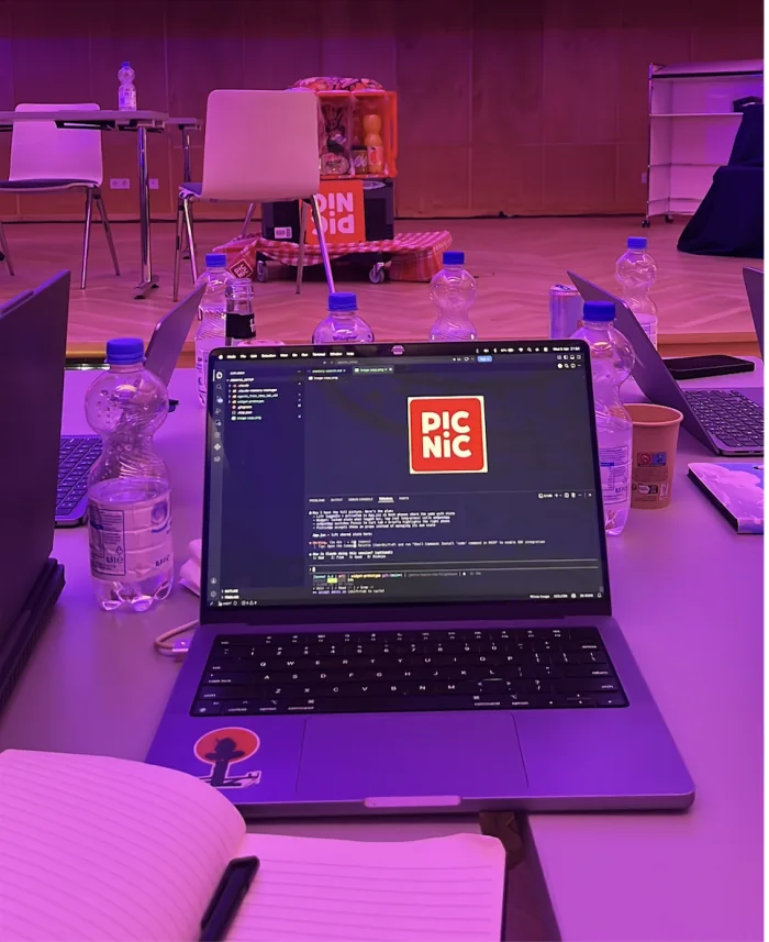 Q-Hack coding table with laptop and Picnic demo